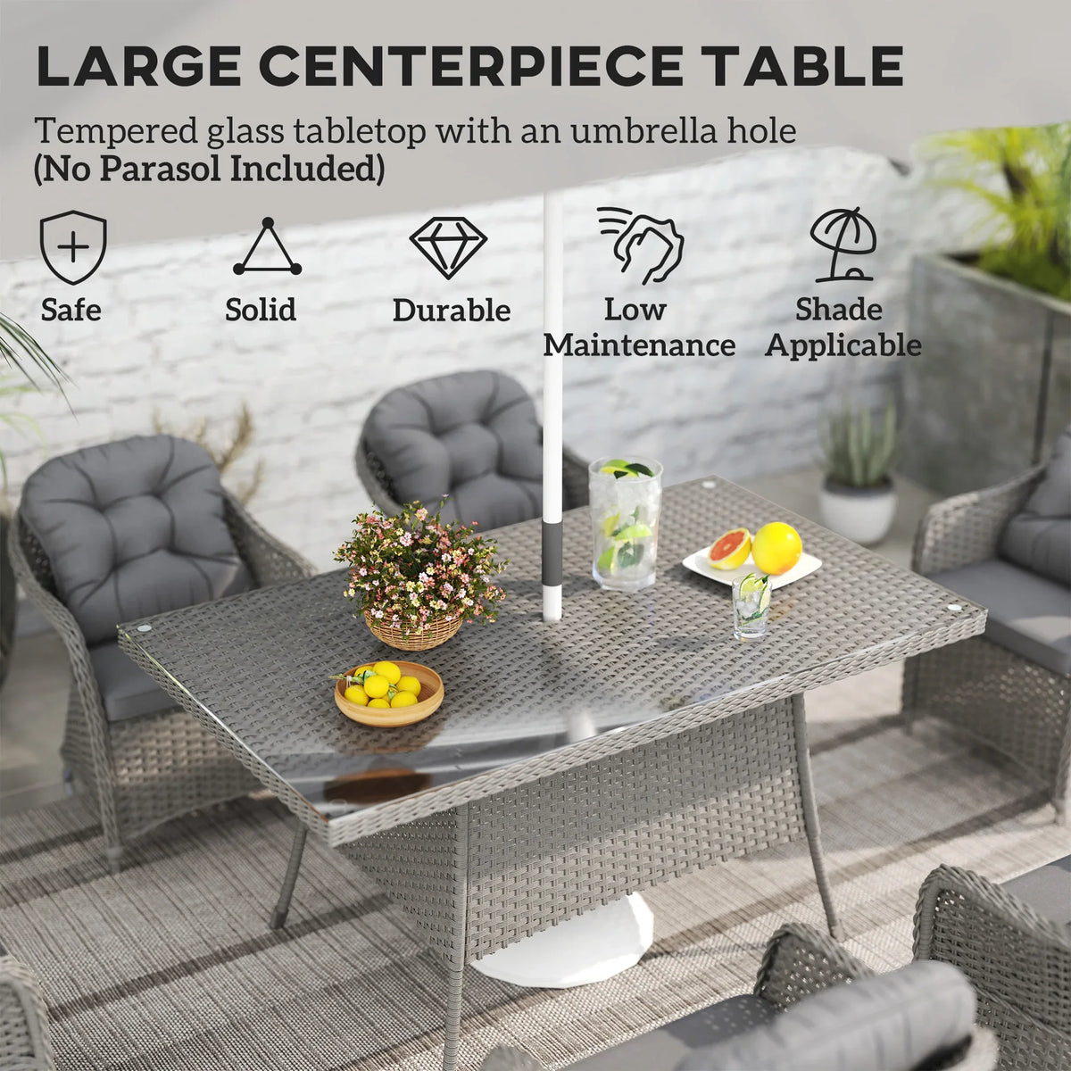 Large light grey rattan dining table with glass top and umbrella hole