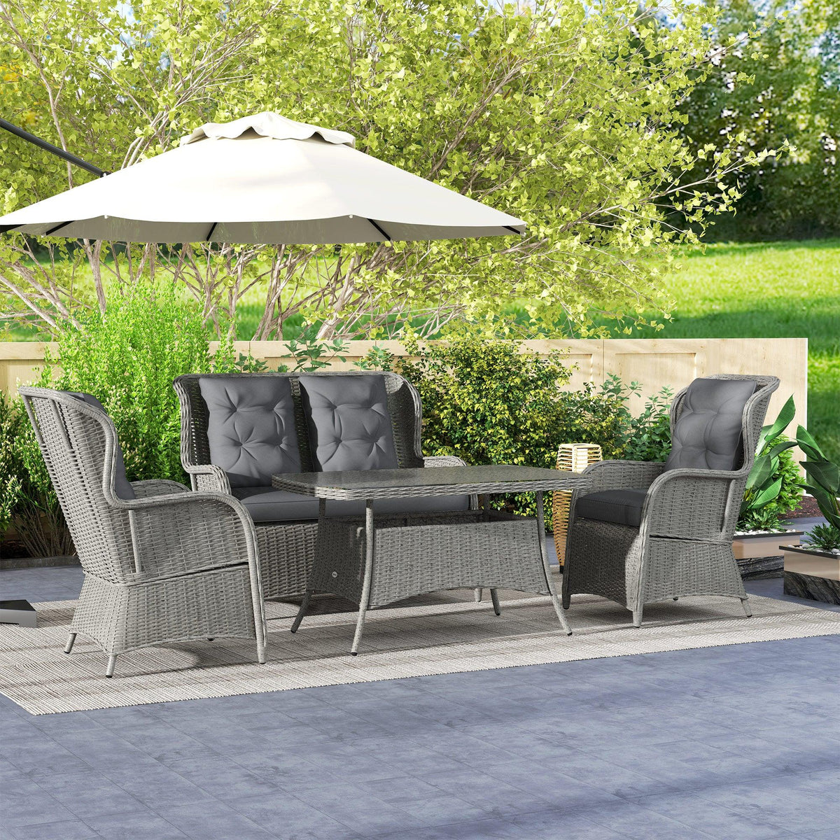 Light gray rattan garden sofa set with high-back chairs and clear tempered glass table