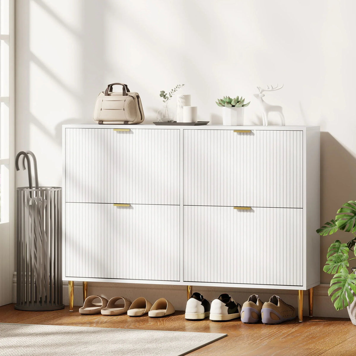 White shoe cabinet with ridged doors and gold accents, four-door closed storage.