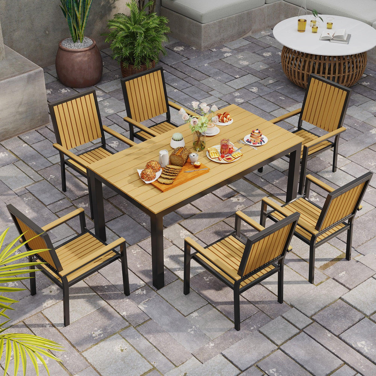 6-seat outdoor dining set with yellow slat chairs and rectangular table on dark aluminum frame