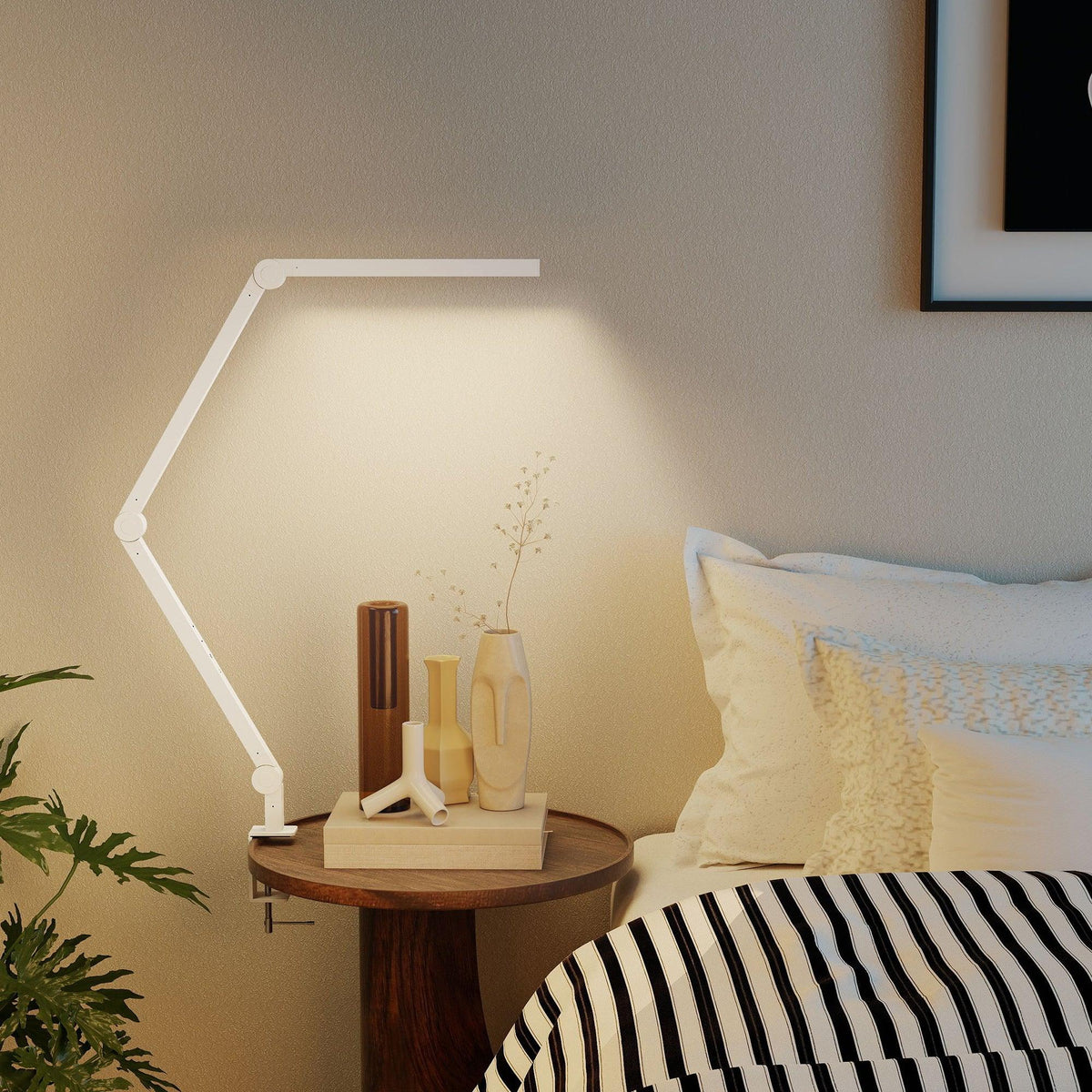 White LED desk lamp with clamp base and angled swing arm over a round side table
