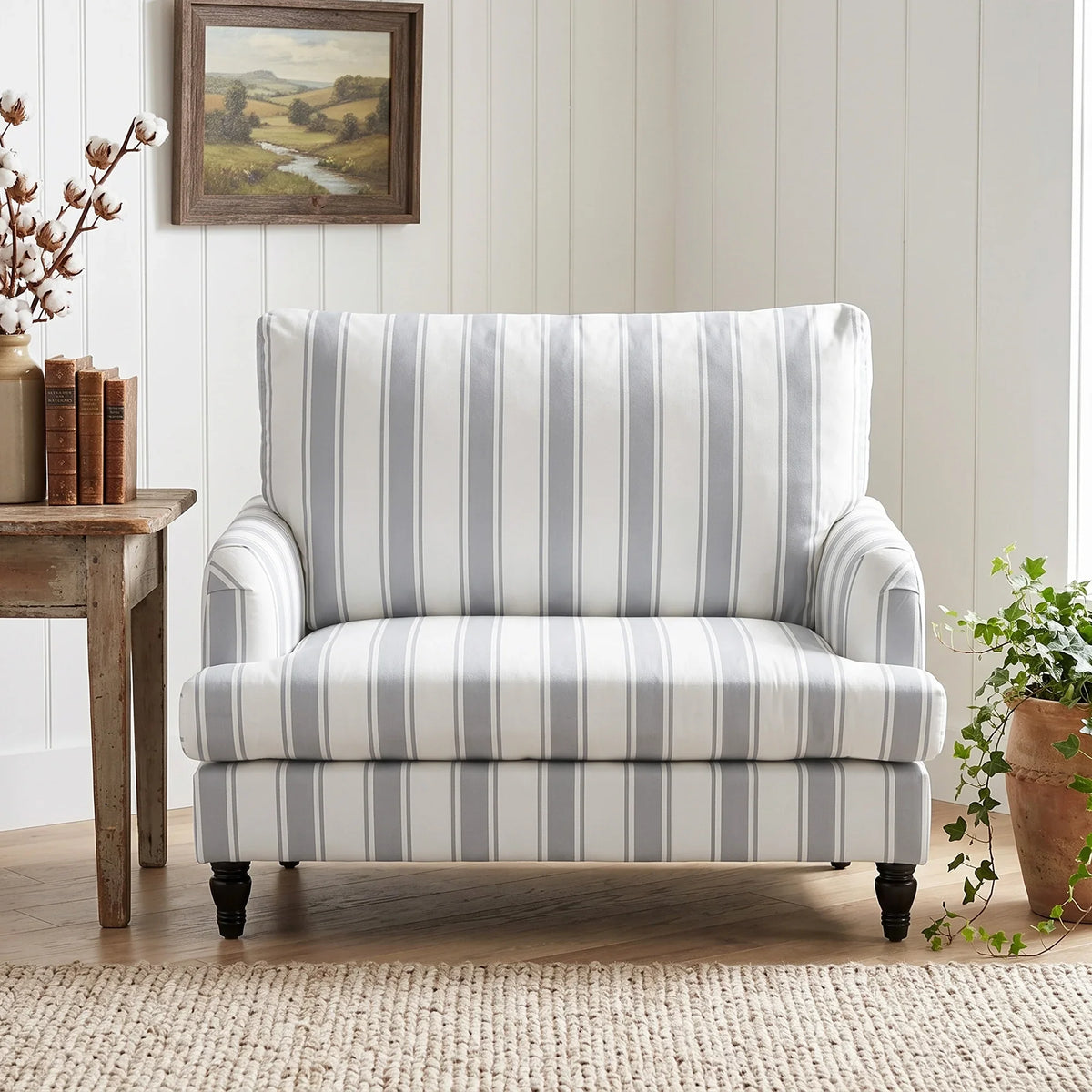 Grey striped velvet armchair with wide seat, supportive backrest, and dark turned legs
