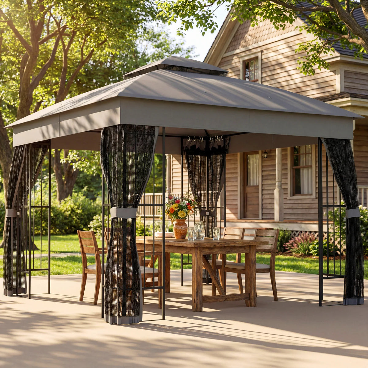 Grey outdoor gazebo with black mesh curtains and double-roof canopy over patio seating