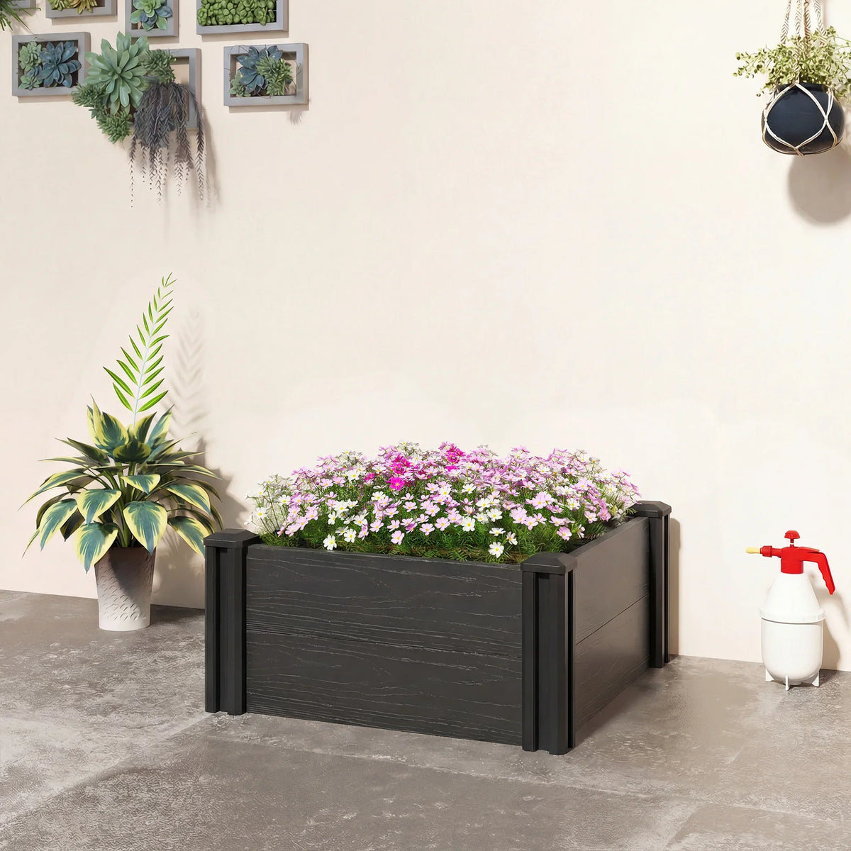 Dark grey vinyl raised garden bed with flower plants, rectangular modular frame