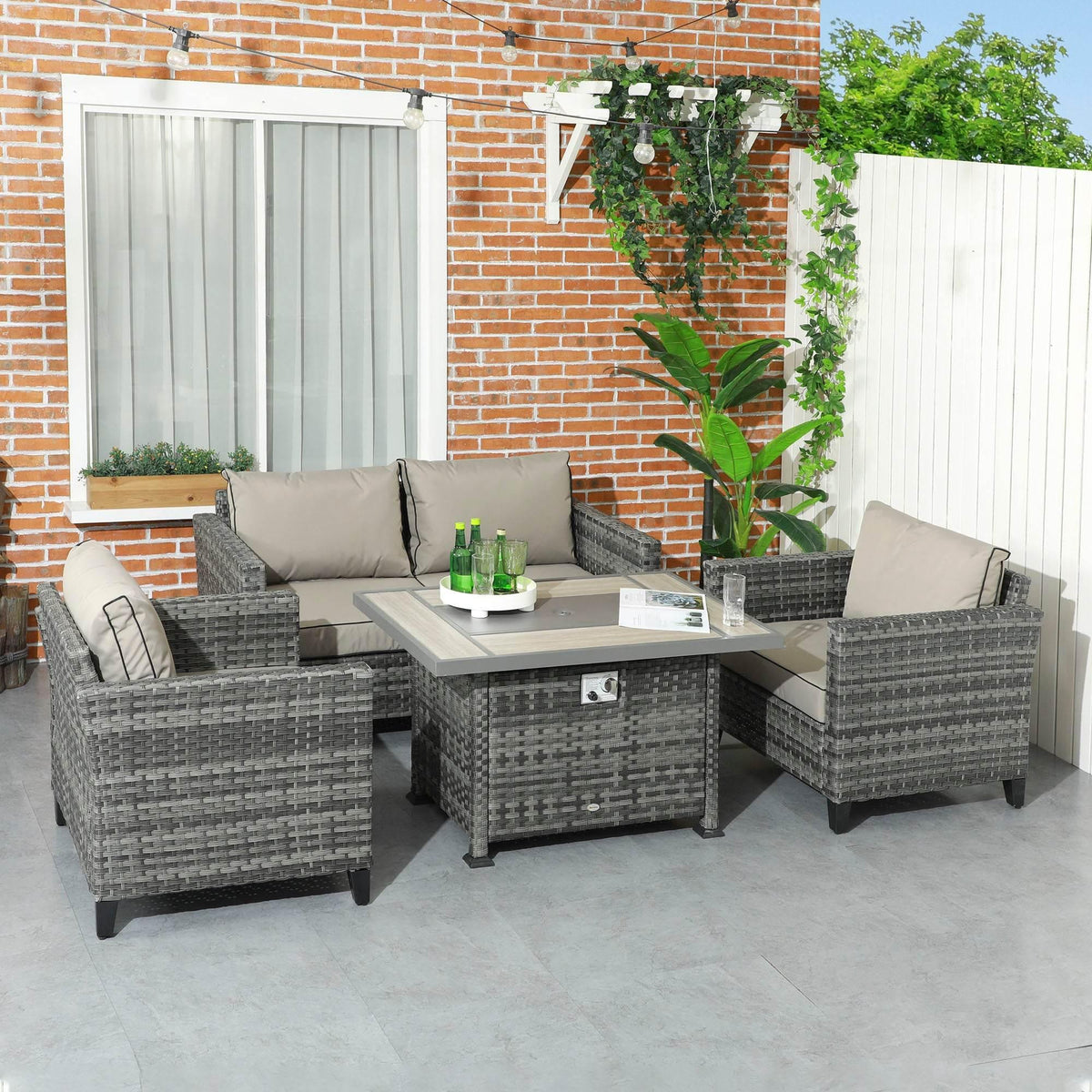 Grey rattan patio sofa set with cushioned seating and fire pit coffee table