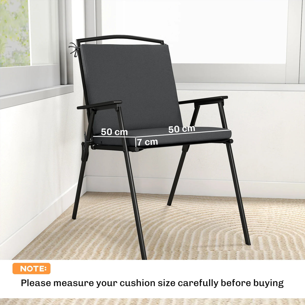 Dark gray outdoor seat cushion set with tie straps on a patio chair