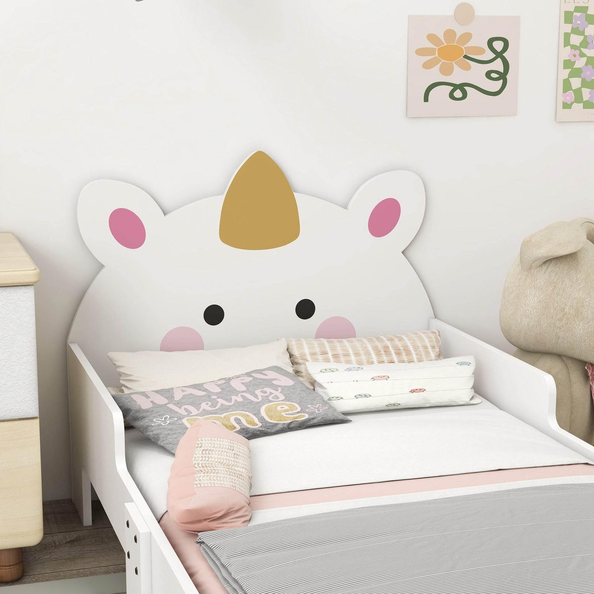 White toddler bed with cute animal headboard design and safety side rails
