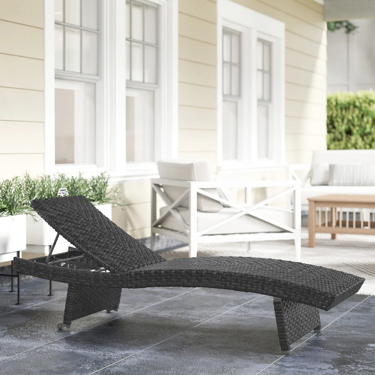 Black folding PE rattan sun lounger with reclining back and low frame