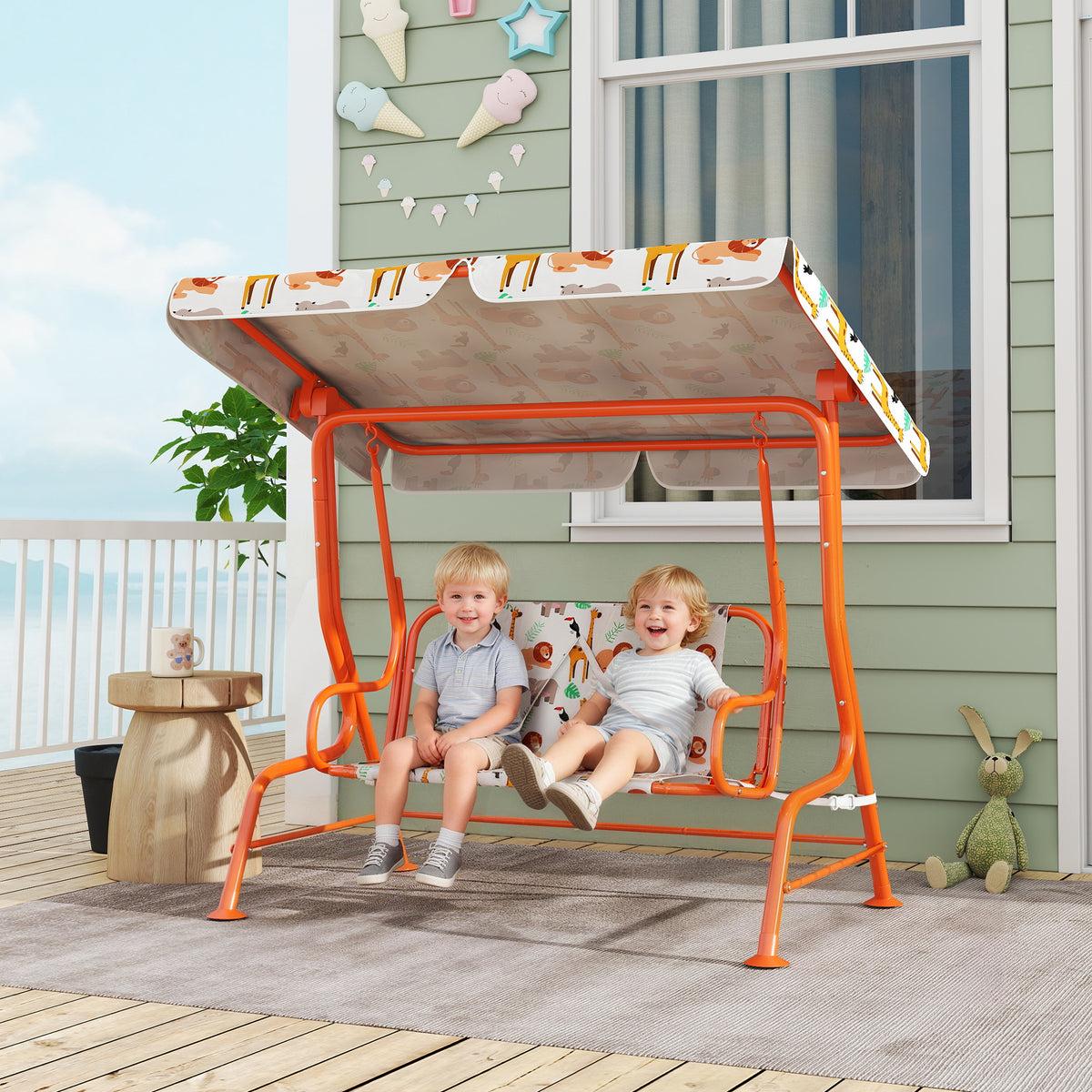 Kids 2-seat porch swing with orange frame, animal print seat pad, adjustable canopy