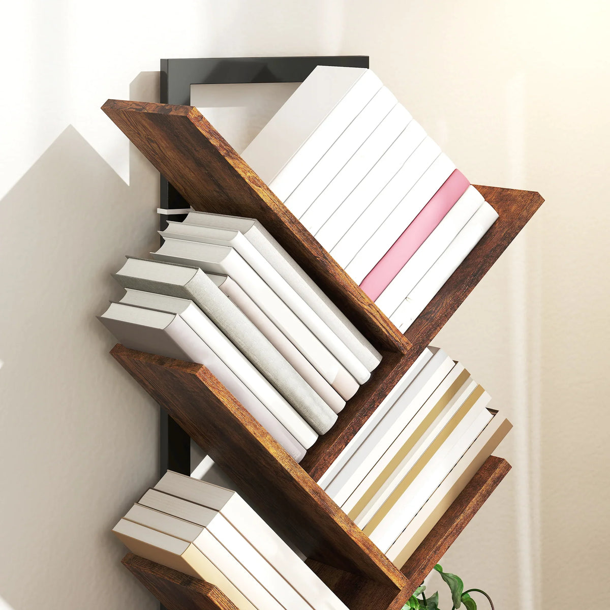 Close view of tree bookcase tiers with dark wood-effect shelves and black steel supports