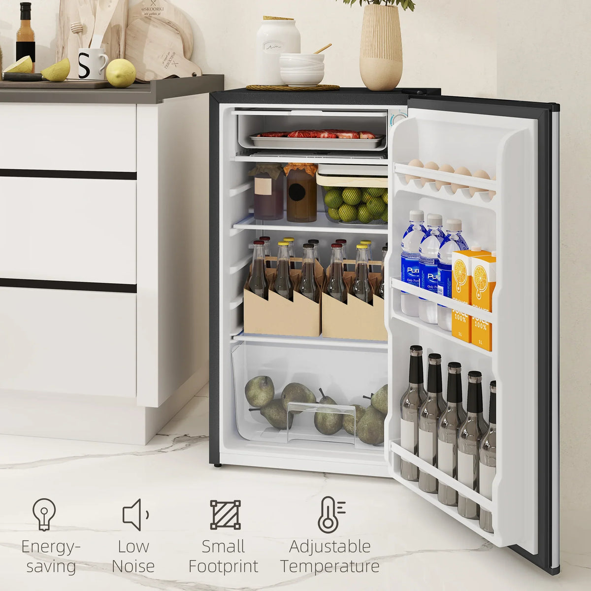Under-counter mini fridge open with organized freezer and cooler sections, bottles and trays