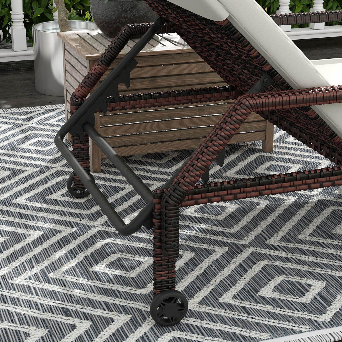 Brown rattan chaise recliner frame with beige cushion and front wheel
