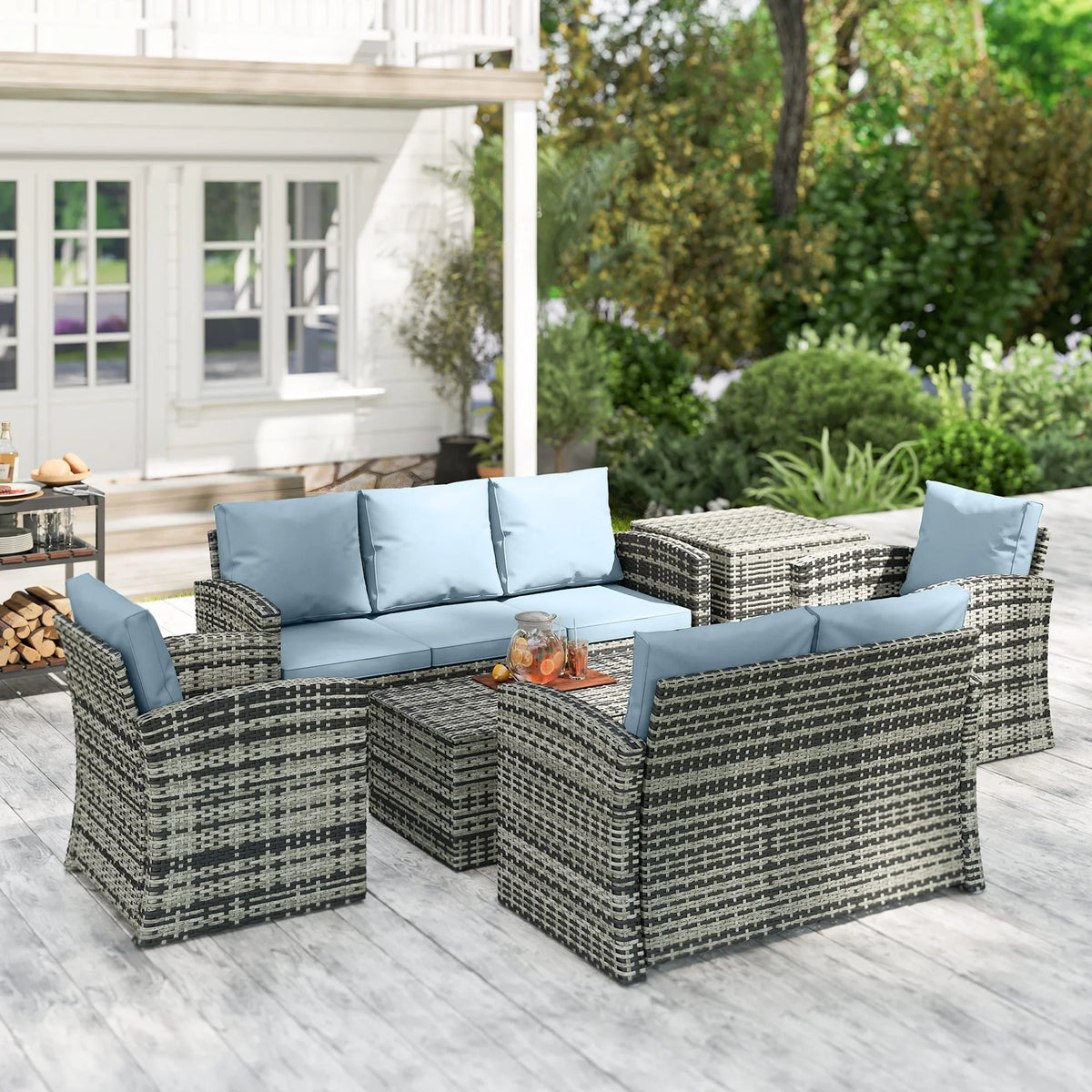 Grey woven rattan 7-seat outdoor sectional with light blue cushions and storage coffee table