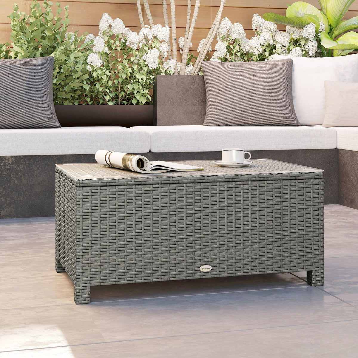 Light grey rattan coffee table with glass top and front panel detail