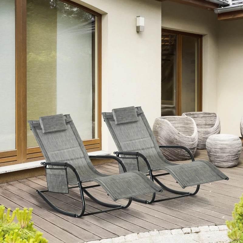 Set of two dark grey rocking patio loungers with breathable mesh seats and headrest pillows