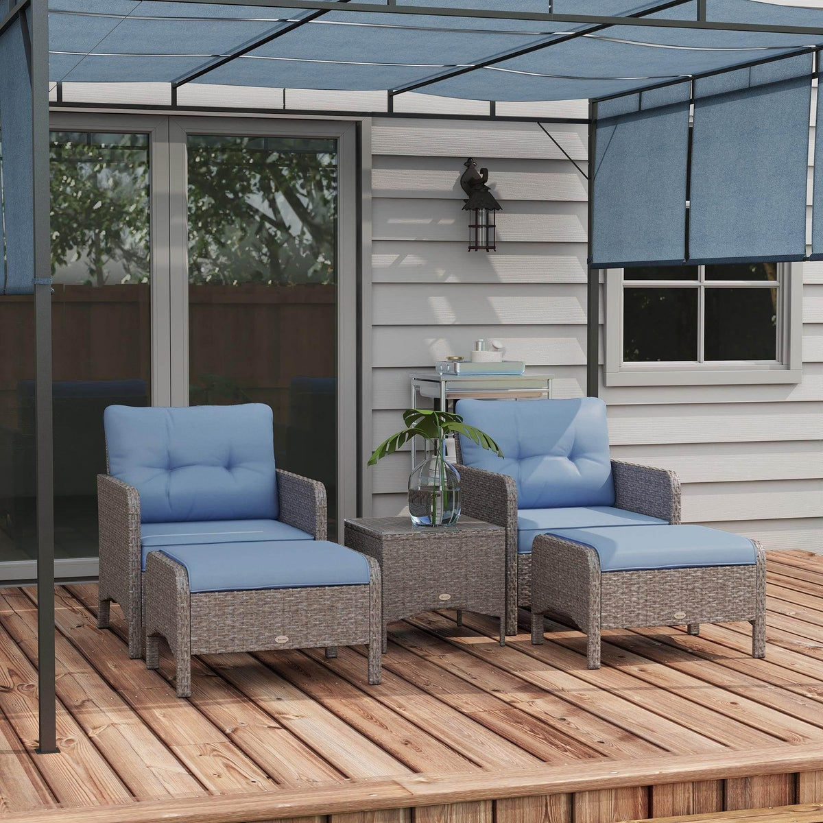 Outdoor armchair set with gray PE rattan frames and blue seat cushions, viewed on wooden deck