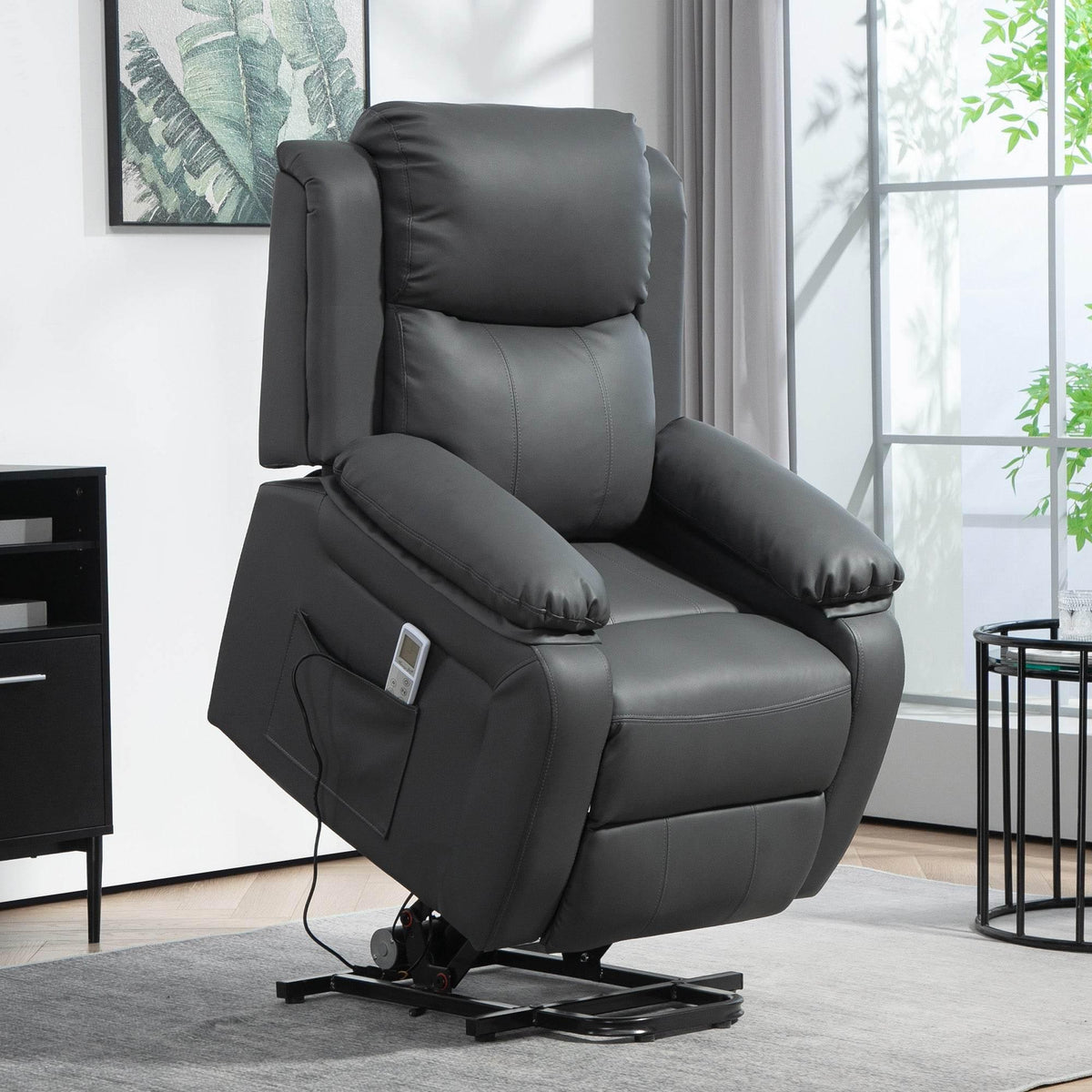 Dark grey power lift recliner chair with padded armrests and footrest