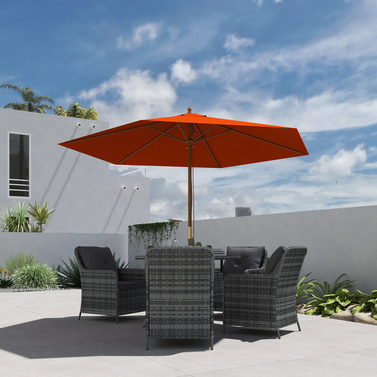 Orange garden parasol with wooden pole over outdoor lounge chairs and open patio