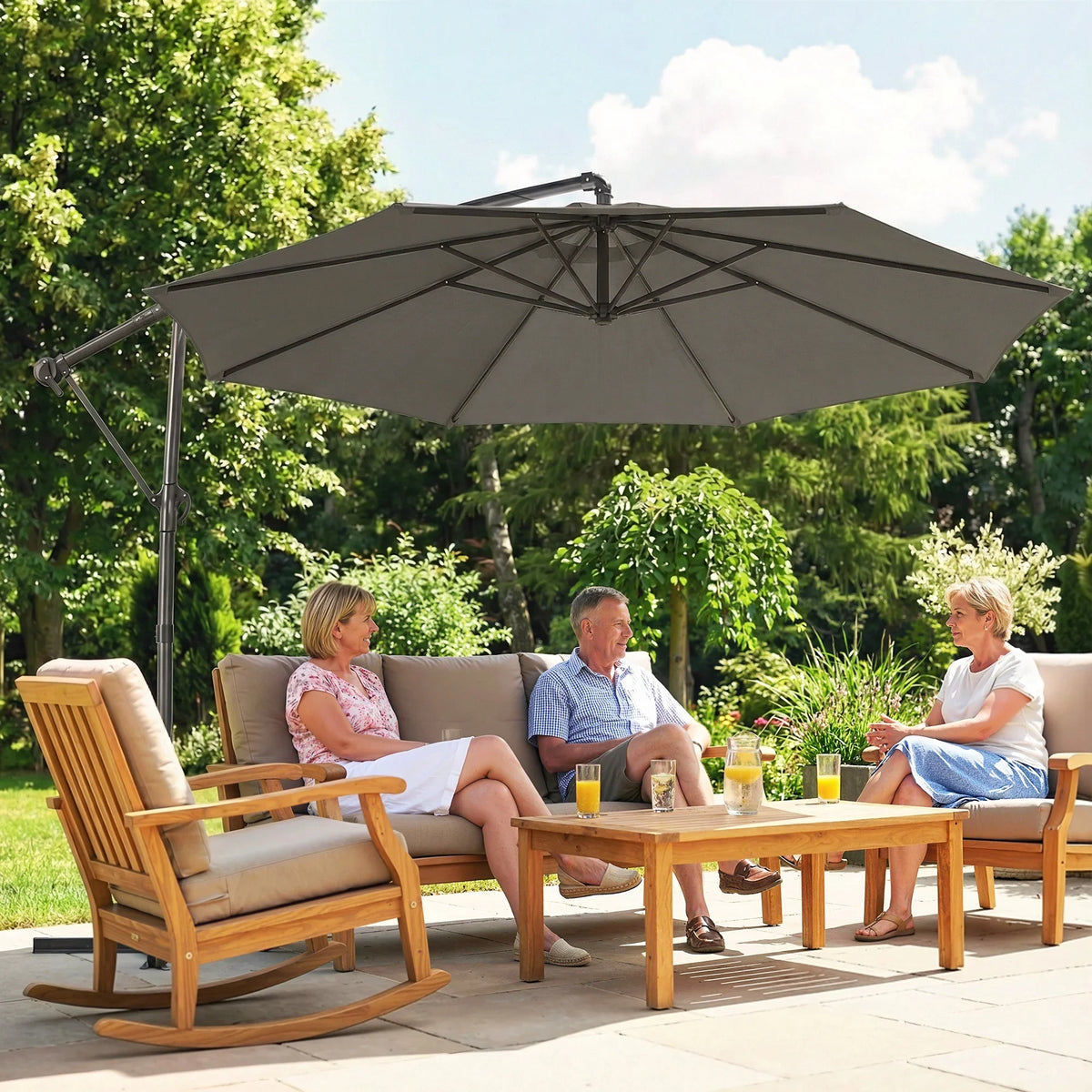 Grey cantilever patio umbrella open above outdoor table and chairs
