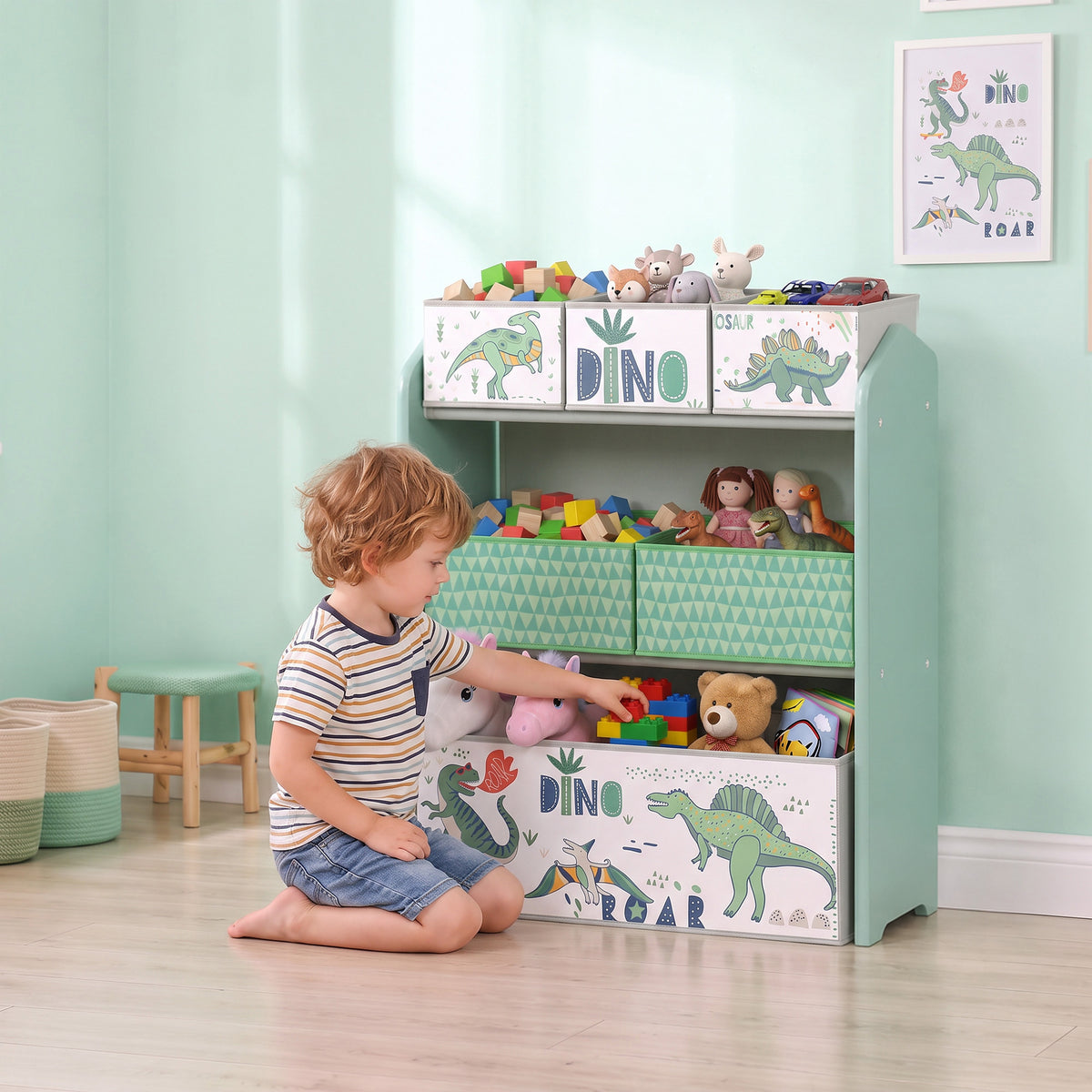 Light green kids toy storage rack with dinosaur printed panels and fabric drawers, side view