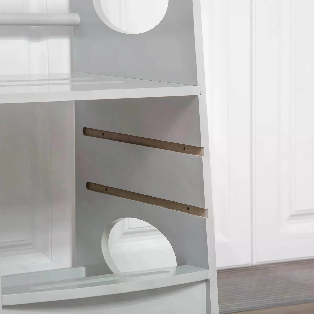 Close-up of grey safety rail and wooden support bars on kids step stool