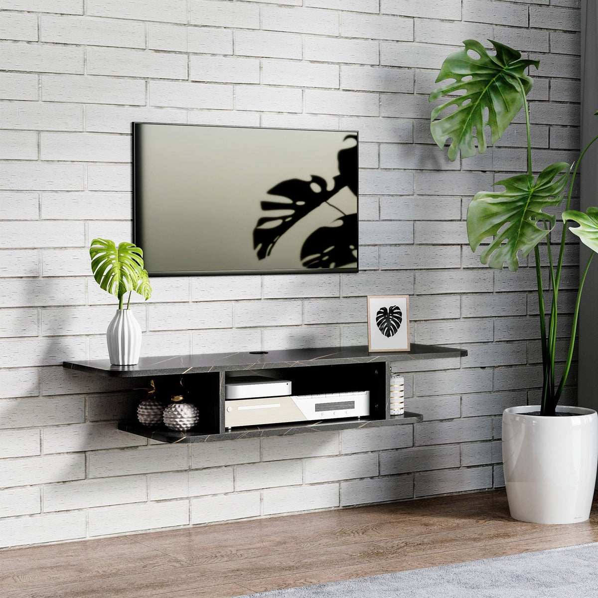 Black floating TV stand with open shelves and media storage beneath a wall-mounted TV.