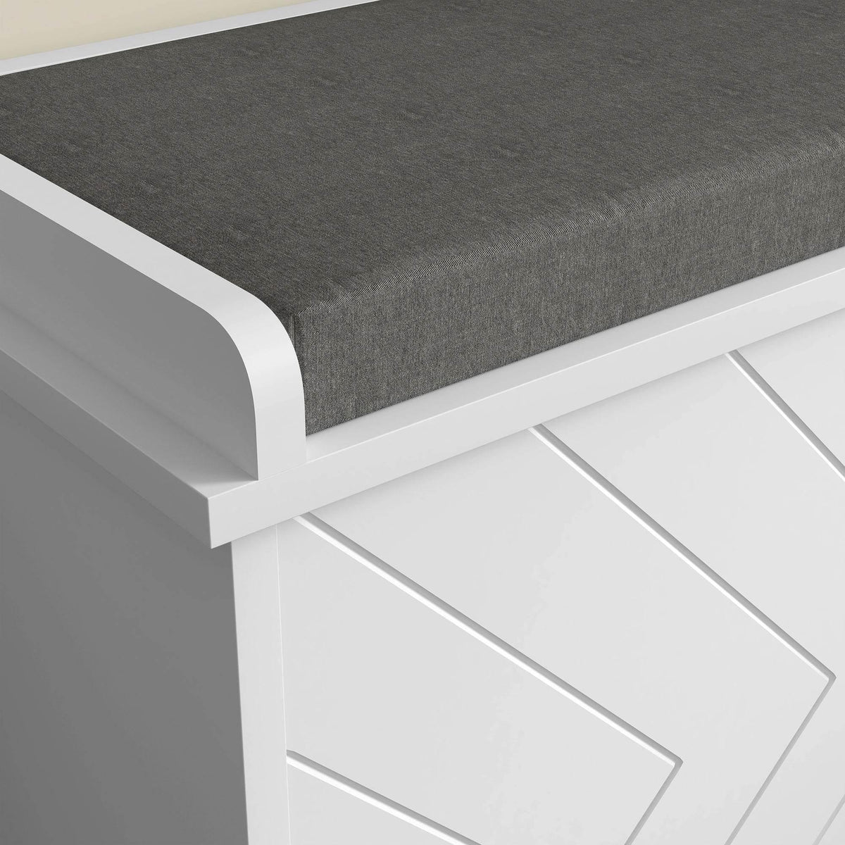 Gray cushioned top on a white shoe storage bench with rounded corner edging.