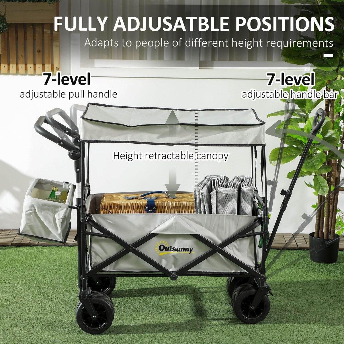 Grey folding beach wagon with height-adjustable handlebar positions and retractable canopy.