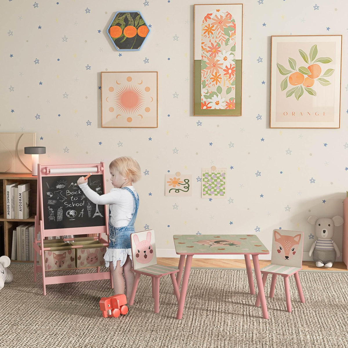 Kids art easel set with pink table, small chairs, and animal storage baskets
