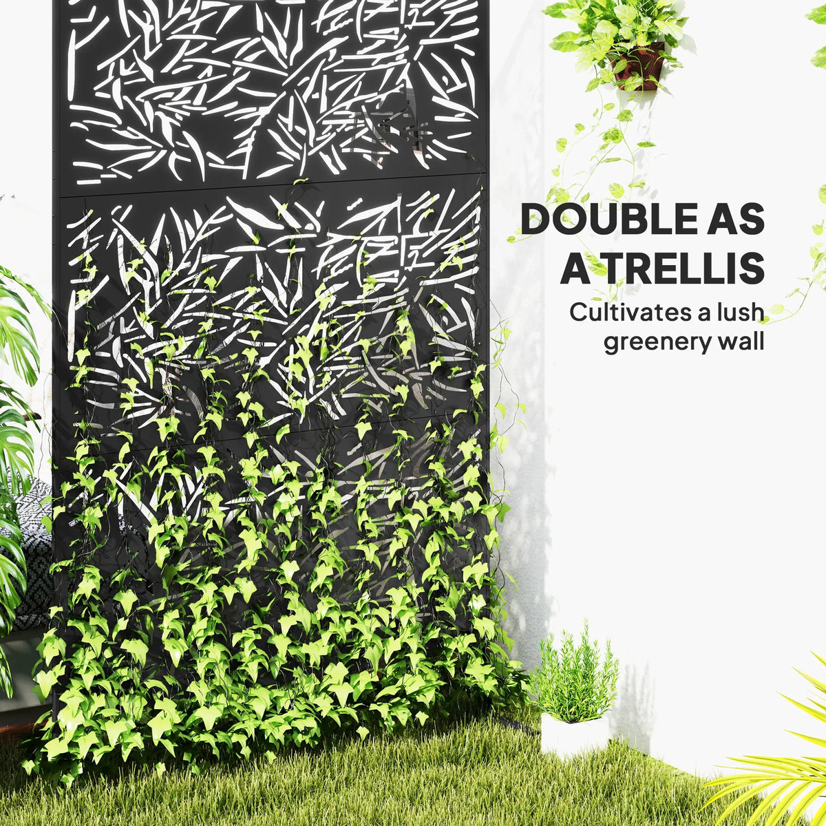 Black bamboo-style privacy screen with metal leaf pattern beside dense green plants