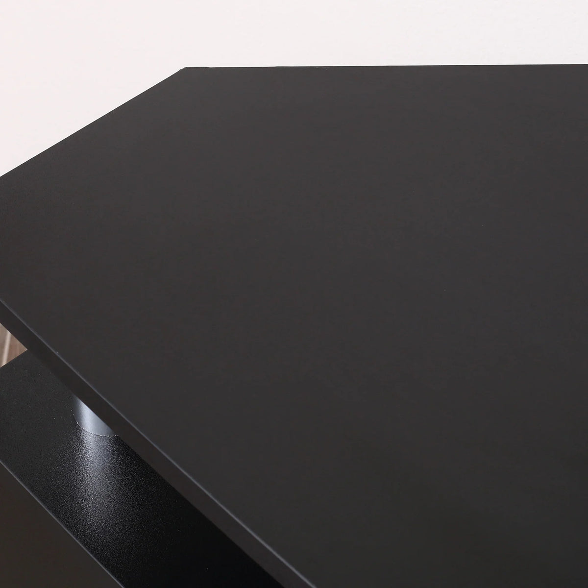 Black tabletop surface of TV unit cabinet with smooth matte finish