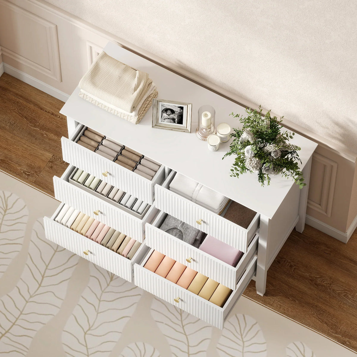 White fluted dresser chest open at an angle with multiple drawers visible