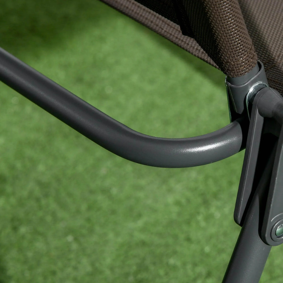 Armrest joint and curved frame of an outdoor folding mesh chair, shown close-up