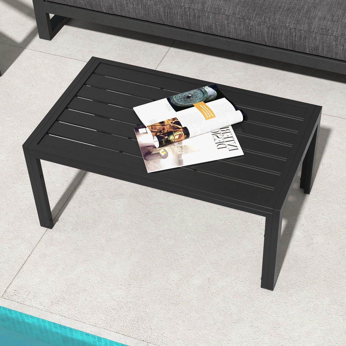 Black slat tabletop side table with magazine on top and four sturdy legs