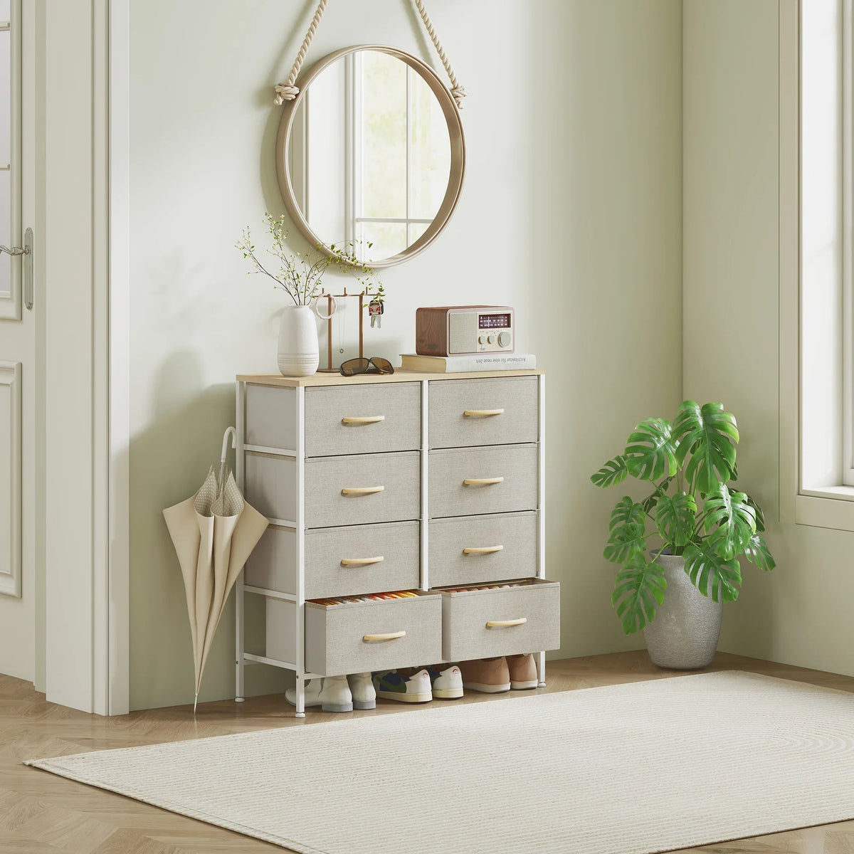 Front-left view fabric chest of drawers with gray fabric drawers, wood top, and gold pulls