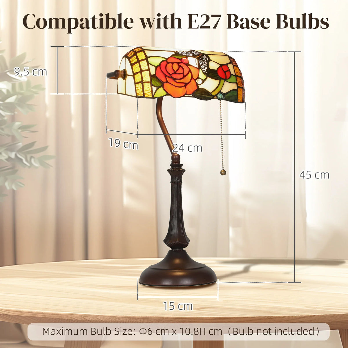 Stained-glass Tiffany table lamp with rose motif, bronze pedestal base, pull-chain