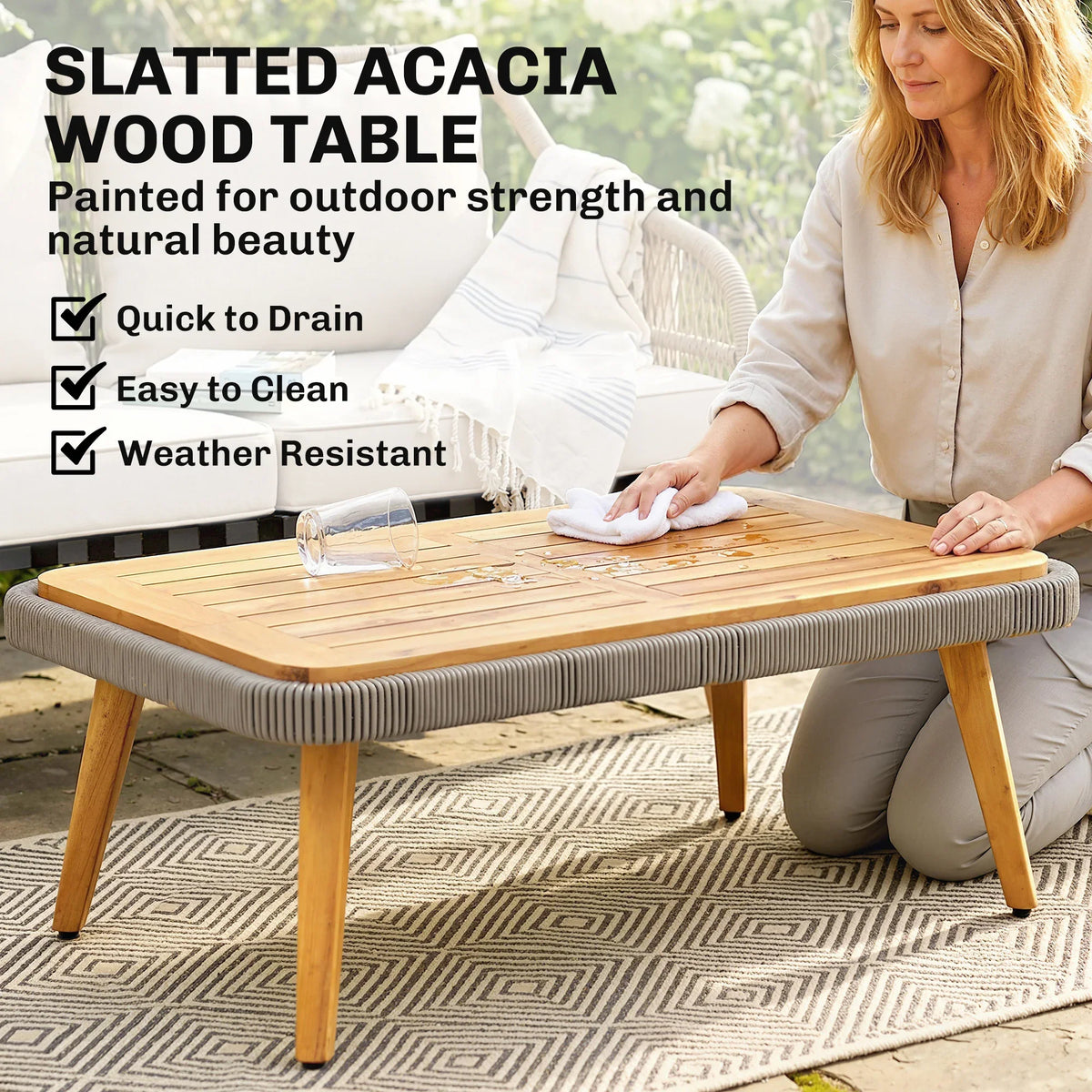 Slatted acacia wood coffee table top with rattan base, being wiped clean