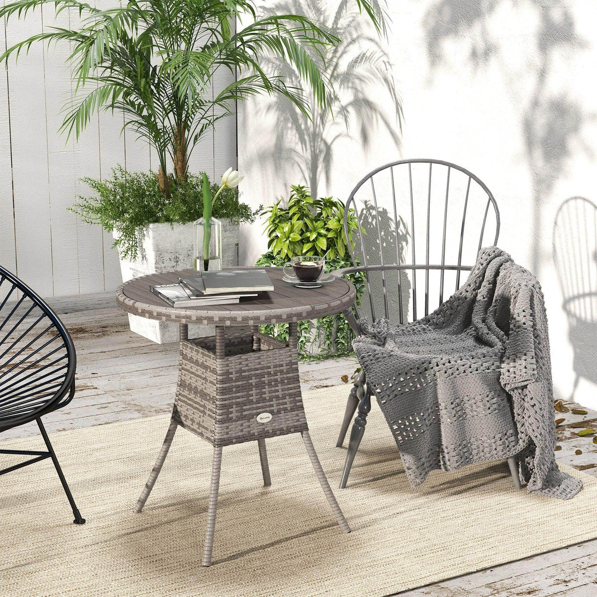 Round grey outdoor dining table with PE rattan weave base and slatted wood-plastic top