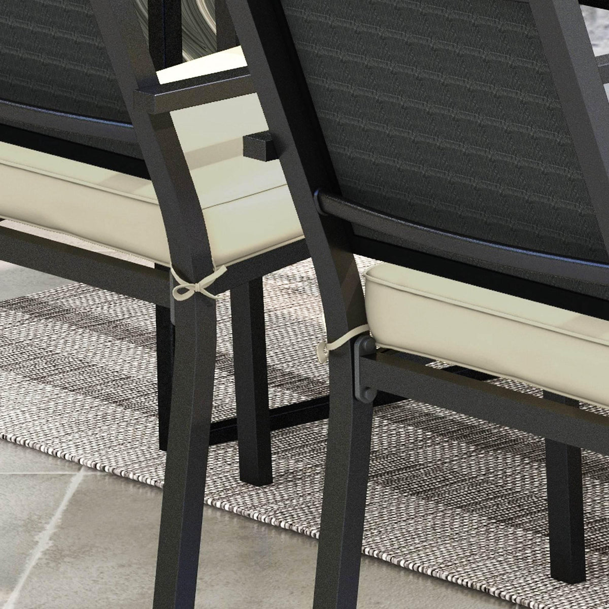 Beige seat cushion tied to a black patio chair frame