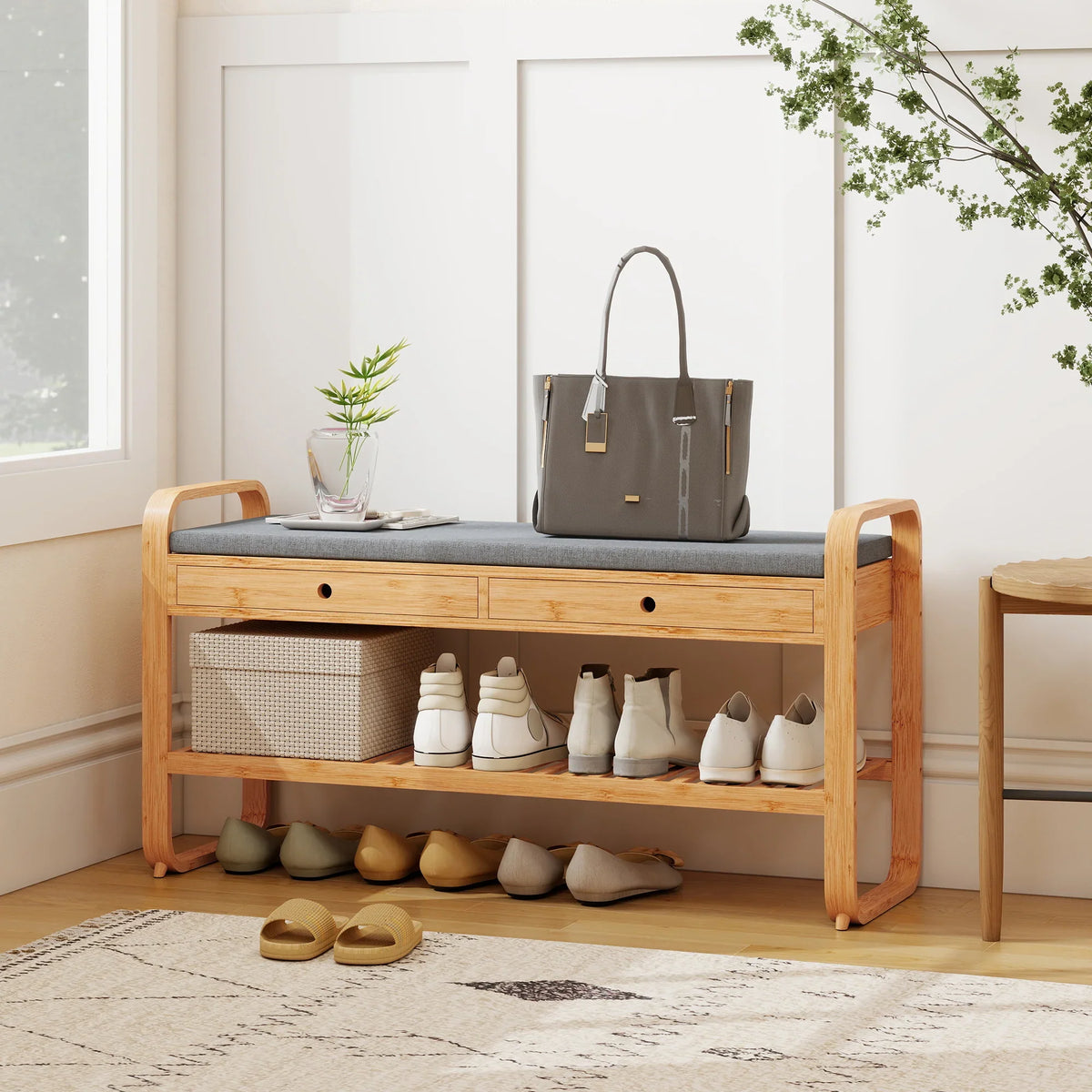 Natural bamboo shoe bench with dark cushioned seat, open shelves, and two drawers