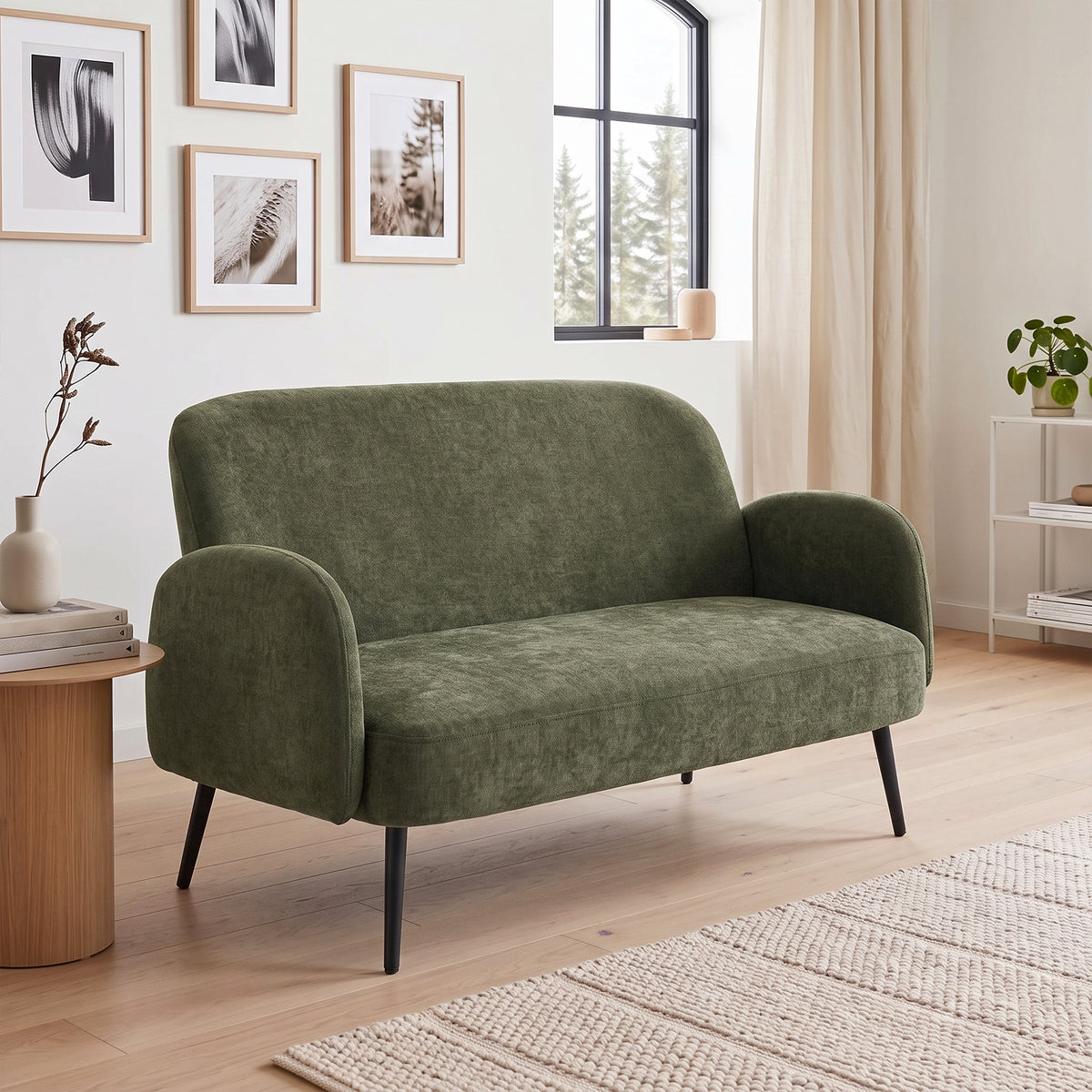 Green velvet 2-seat sofa with rounded arms and short black metal legs
