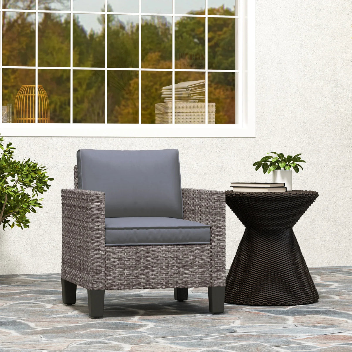 Grey rattan outdoor armchair with dark grey back and seat cushions