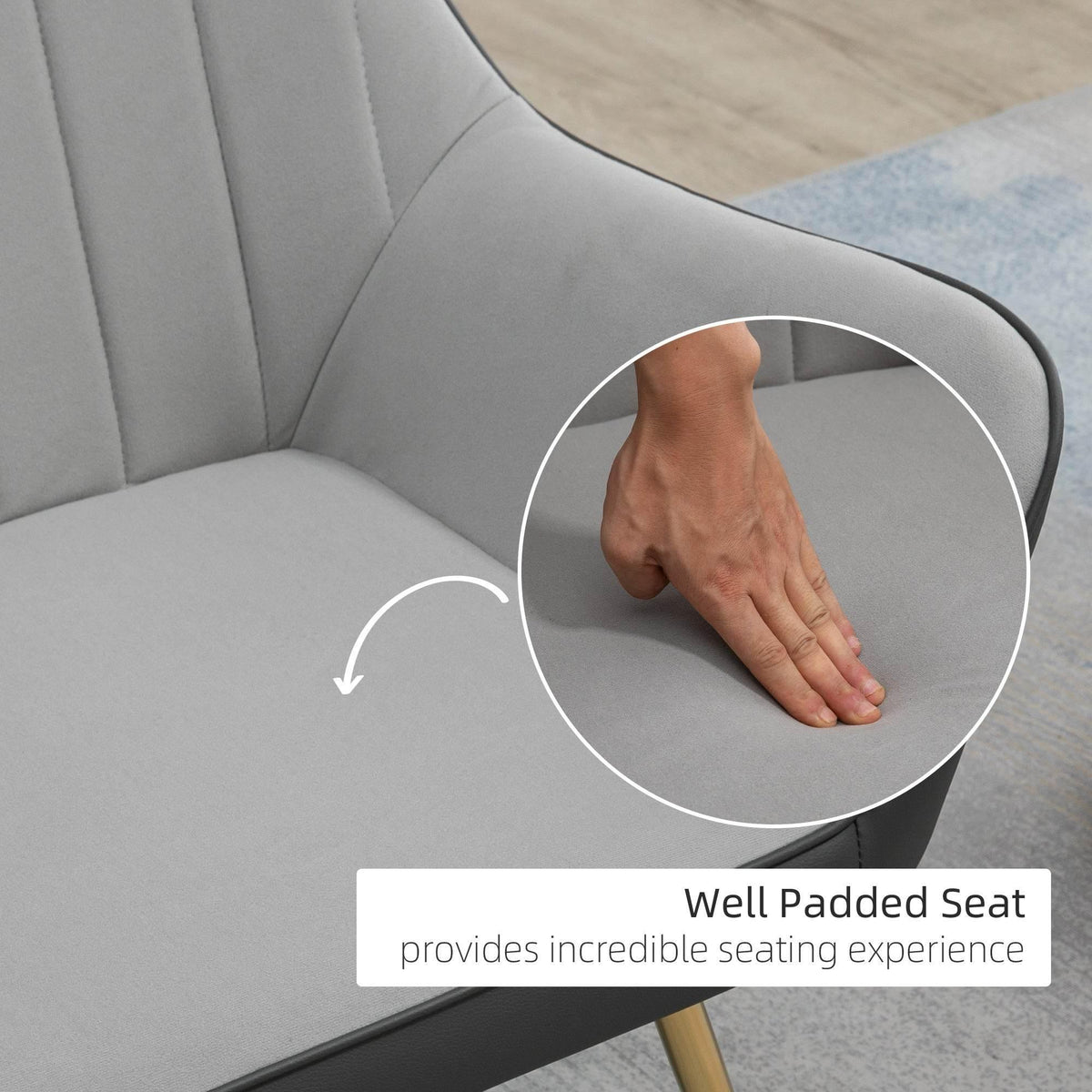 Light grey velvet accent armchair with padded seat and curved armrests
