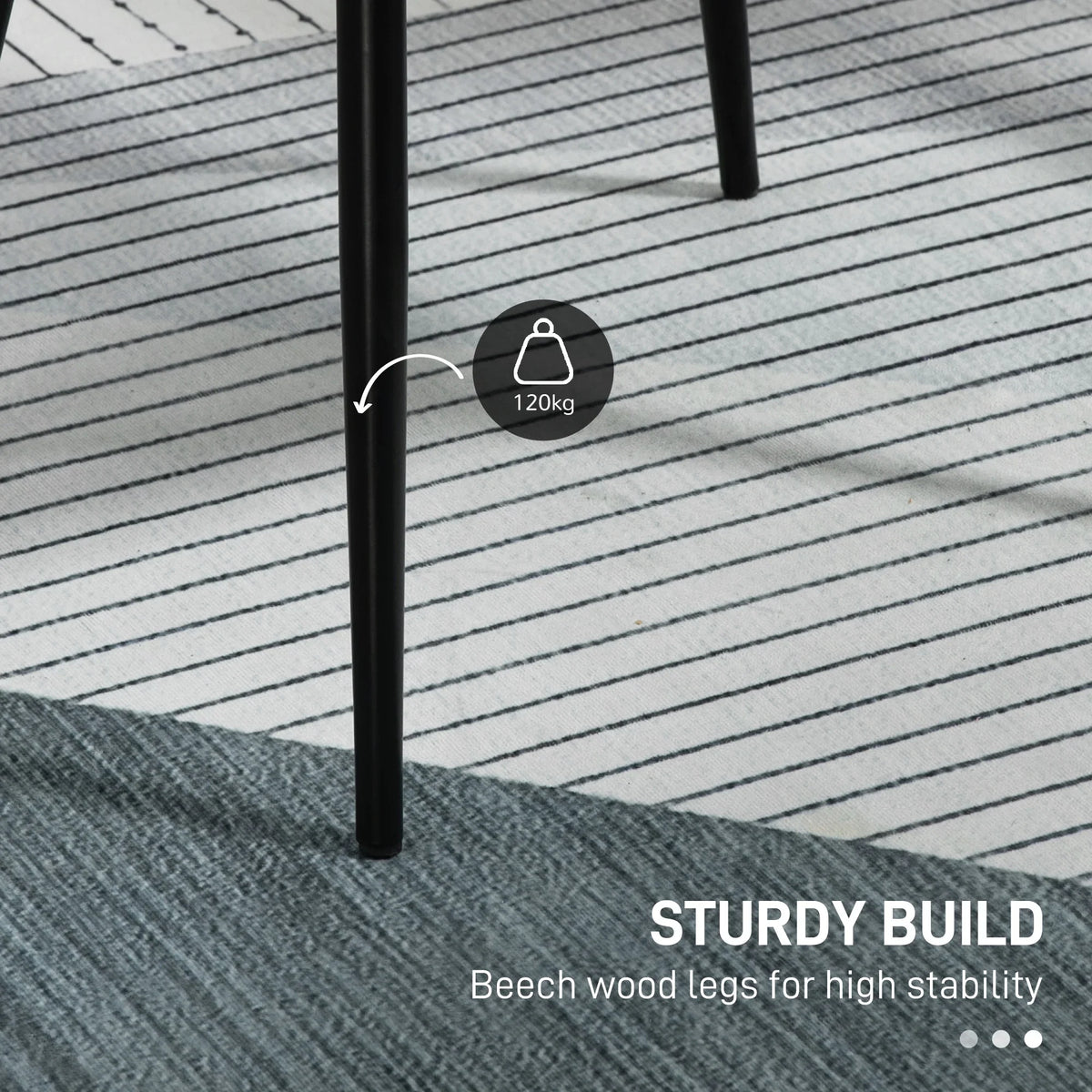 Black beech wood legs on a light grey upholstered dining chair
