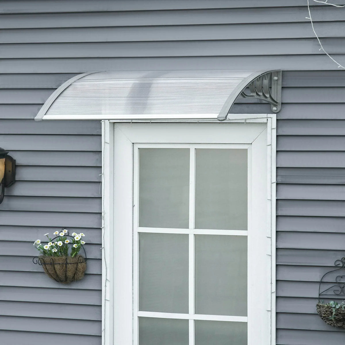 Clear outdoor door canopy awning with arched frame, mounted above a front door