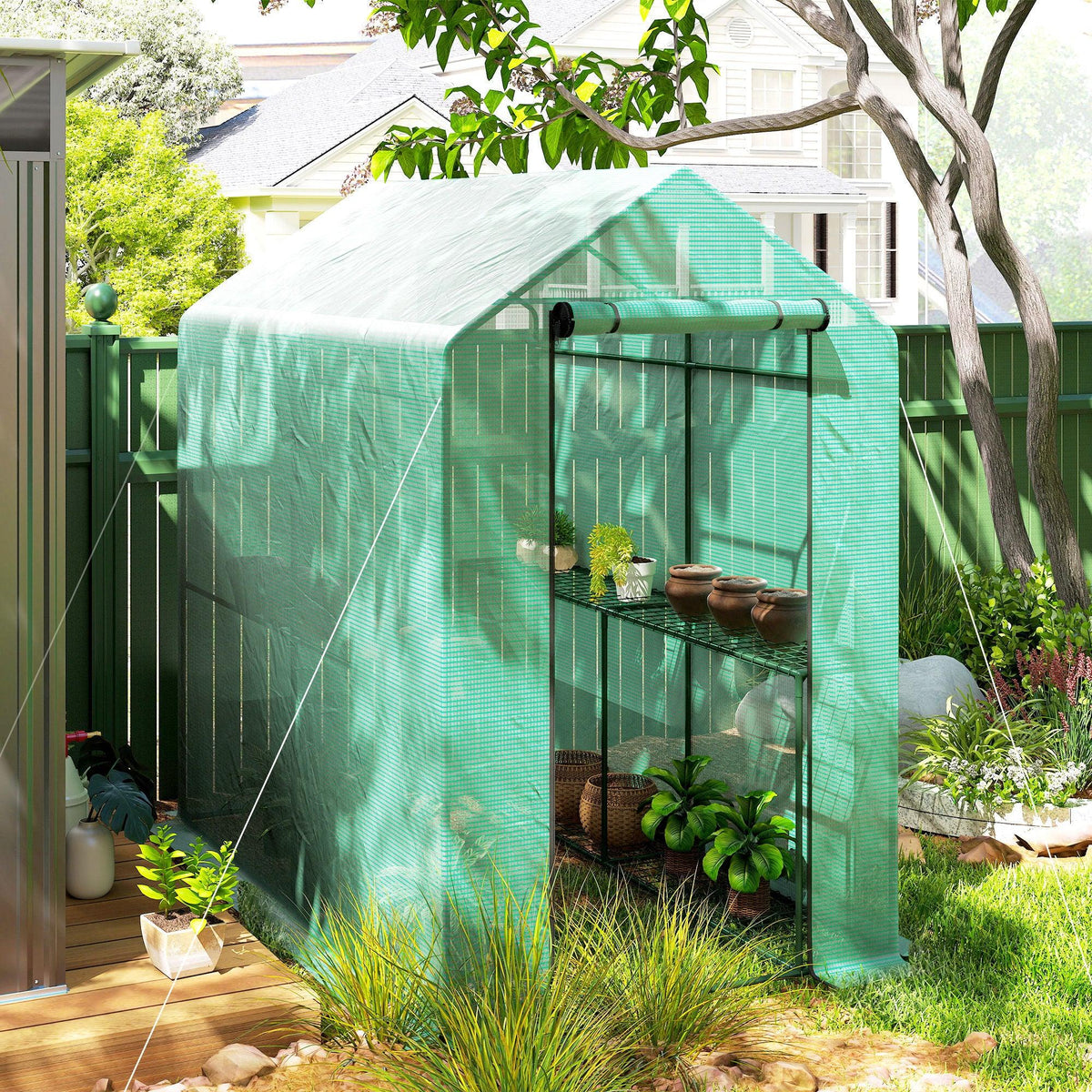 Green walk-in greenhouse with steel frame and PE cover, front roll-up door, side view