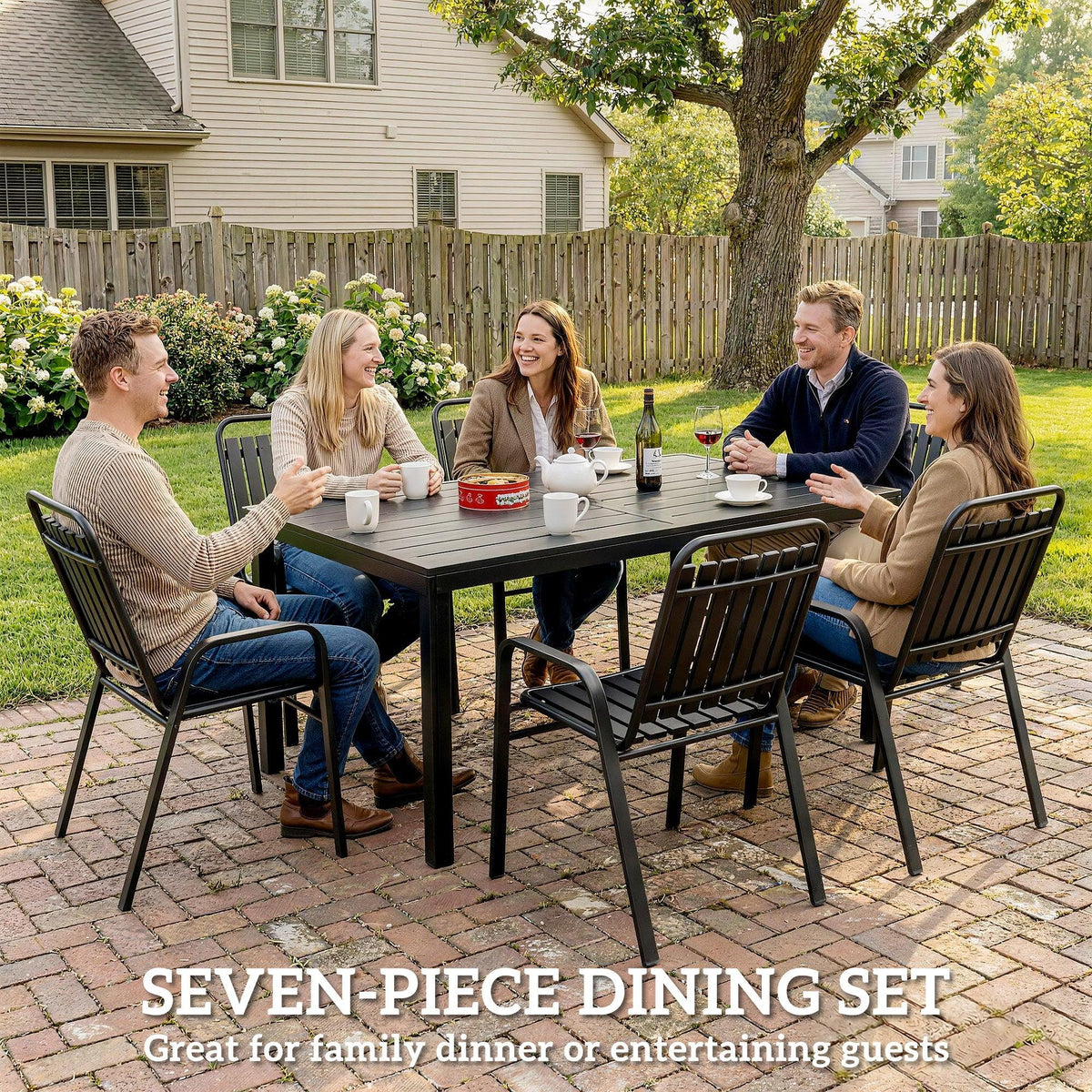 Outdoor dining table with six dark metal slat chairs, set for family meals