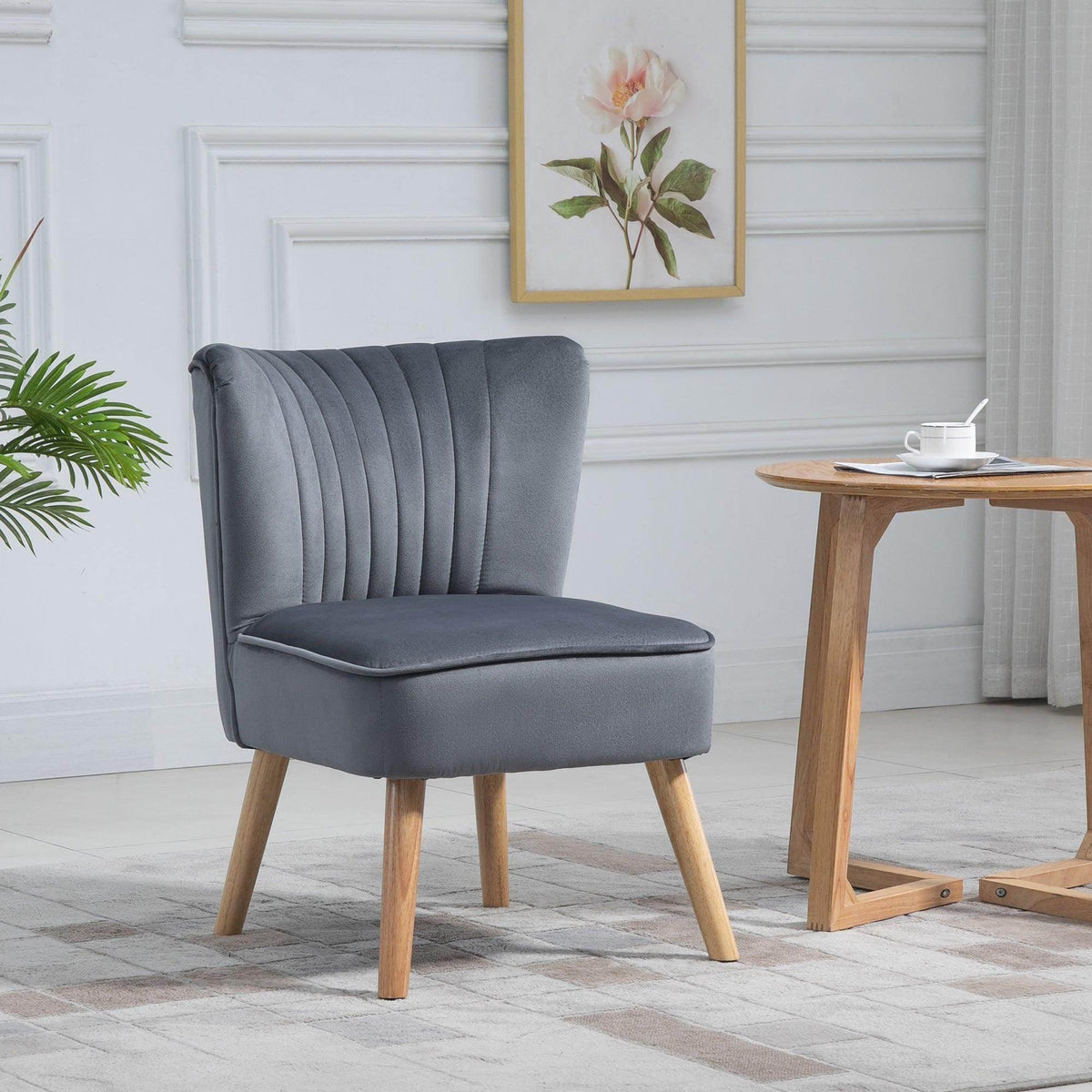 Grey velvet accent tub chair with channel-tufted back, cushioned seat, and wooden legs