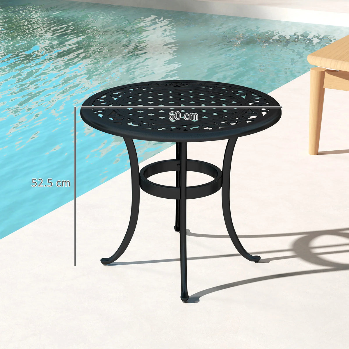 Black round cast aluminum patio end table with openwork lattice tabletop and scroll legs