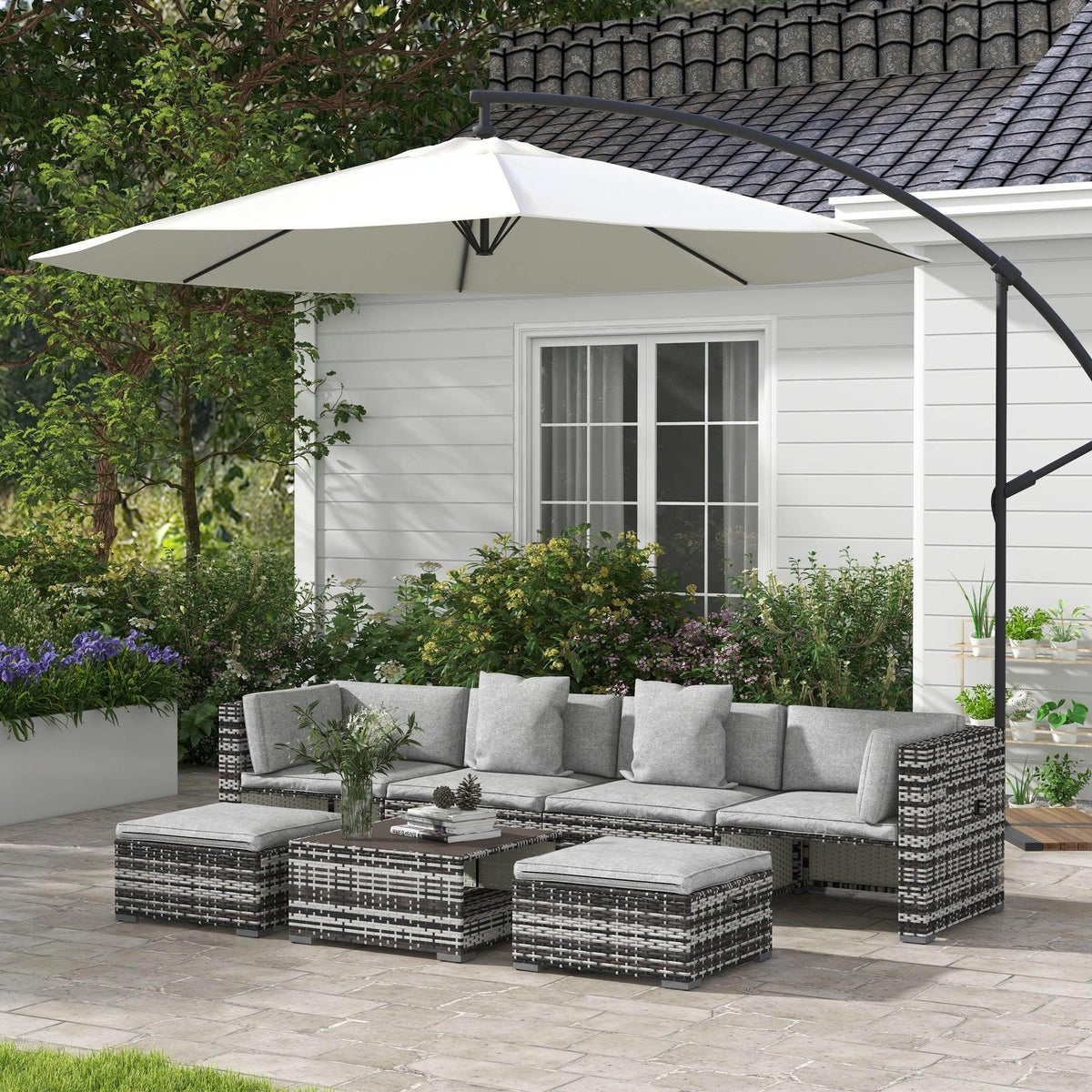 7-piece rattan patio furniture set with grey sectional sofa, ottomans, and coffee table cushions